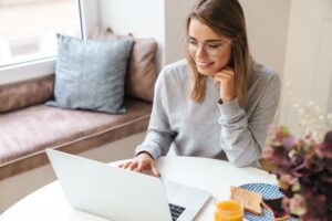 como criar uma empresa​: mulher usando computador na sala de casa